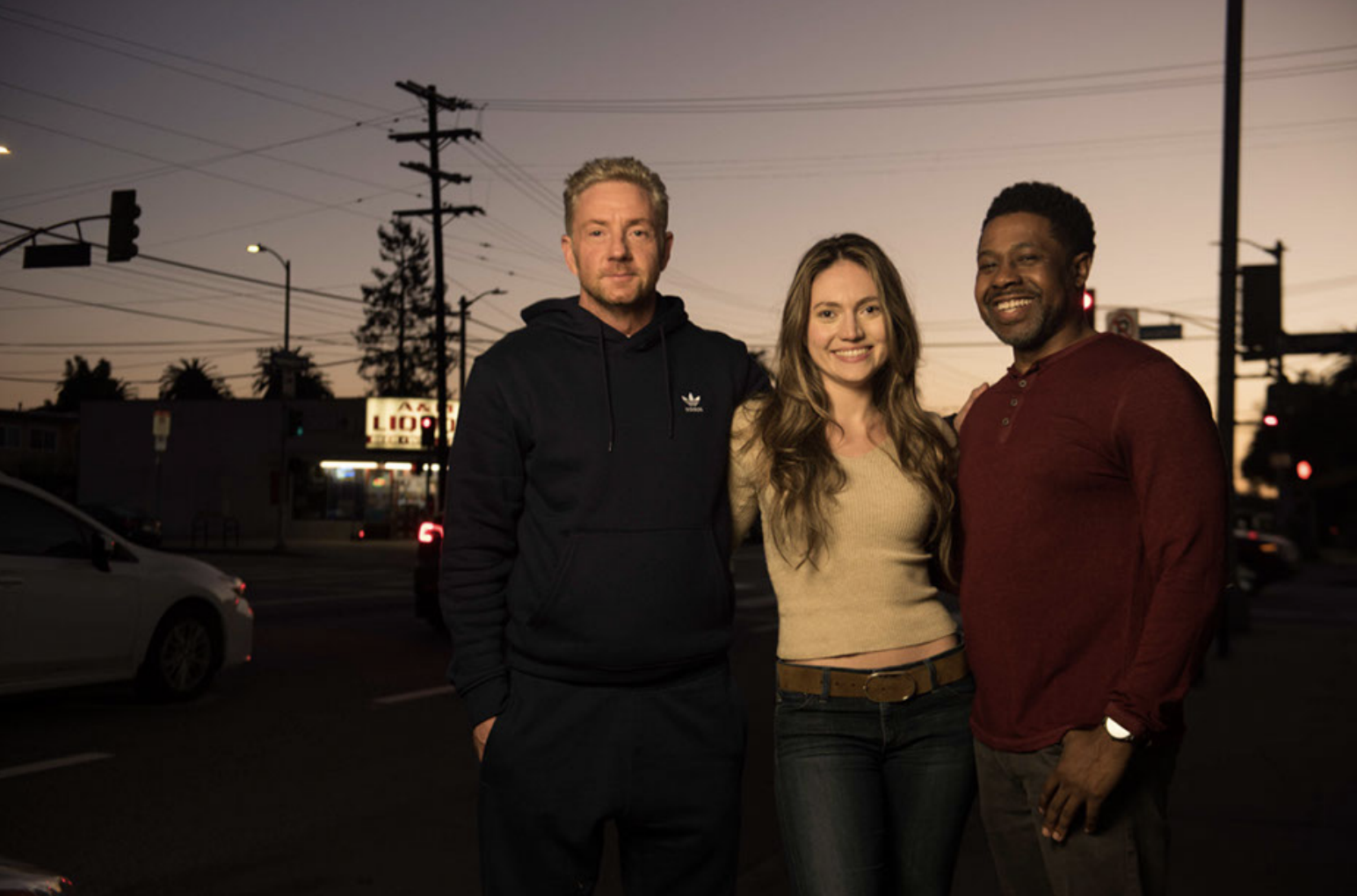 The cast standing together at sunset on a Los Angeles street corner.